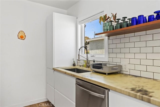 1156 W 26th St, San Pedro, CA 90731 - kitchen with dishwasher, a sink, tasteful backsplash, white cabinetry, and light countertops