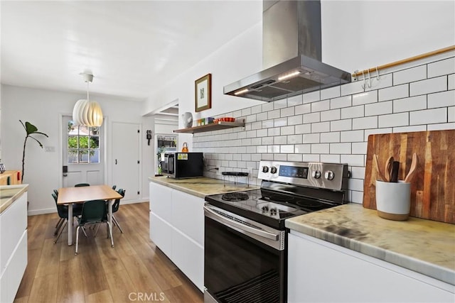 1156 W 26th St, San Pedro, CA 90731 - kitchen with stainless steel range with electric cooktop, island exhaust hood, white cabinetry, light countertops, and wood finished floors