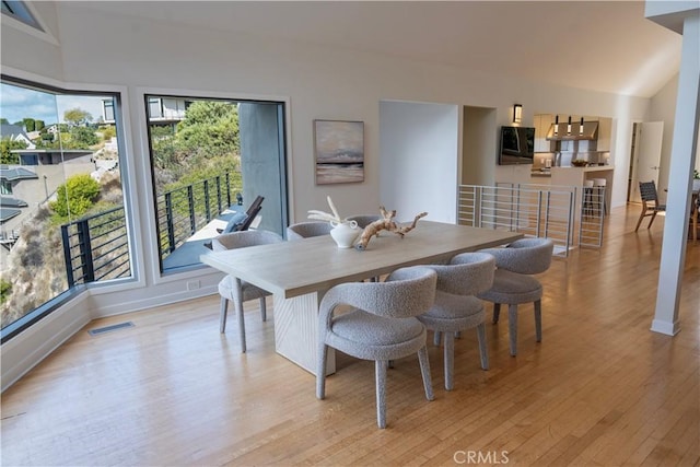 901 Summit Dr, Laguna Beach, CA 92651 - dining room with light wood-style floors, lofted ceiling, and baseboards