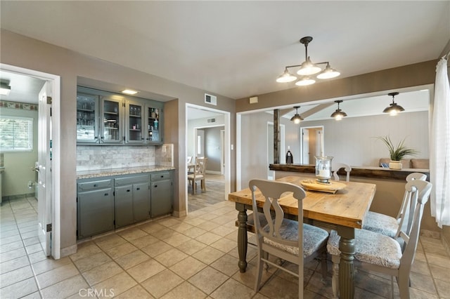 9331 E Mesa Ave, Clovis, CA 93619 - dining space featuring light tile patterned floors and a chandelier