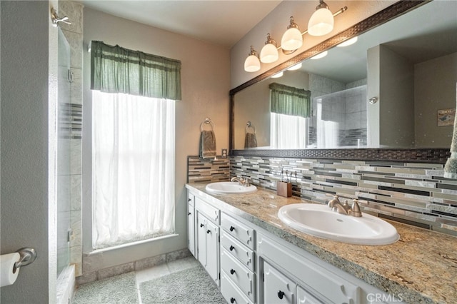 9331 E Mesa Ave, Clovis, CA 93619 - bathroom featuring double vanity, a tile shower, and backsplash