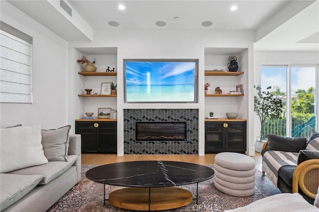1926 Ruhland Ave Unit B, Redondo Beach, CA 90278 - living area with wood finished floors, a tiled fireplace, built in shelves, and recessed lighting