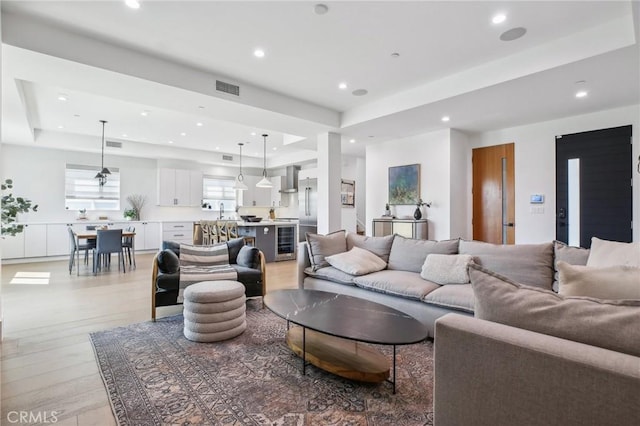 1926 Ruhland Ave Unit B, Redondo Beach, CA 90278 - living room with a tray ceiling, recessed lighting, light wood finished floors, and wine cooler