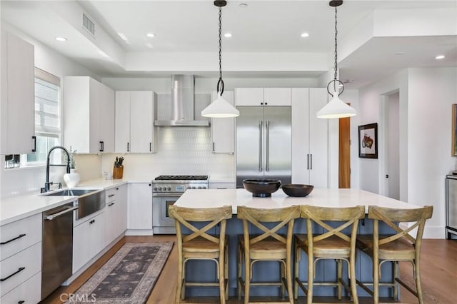 1926 Ruhland Ave Unit B, Redondo Beach, CA 90278 - kitchen with wall chimney exhaust hood, high end appliances, a sink, tasteful backsplash, and light countertops