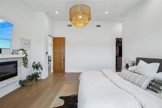 1926 Ruhland Ave Unit B, Redondo Beach, CA 90278 - bedroom featuring wood finished floors, a glass covered fireplace, baseboards, recessed lighting, and a towering ceiling