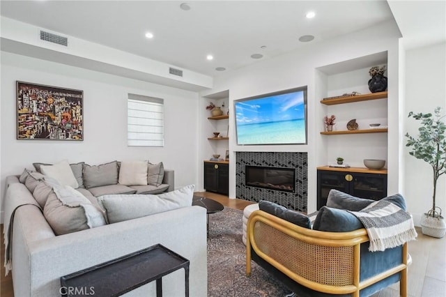 1926 Ruhland Ave Unit B, Redondo Beach, CA 90278 - living area featuring built in features, wood finished floors, a tiled fireplace, and recessed lighting