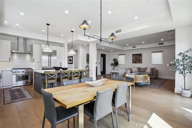 1926 Ruhland Ave Unit B, Redondo Beach, CA 90278 - dining space with light wood-type flooring, recessed lighting, and a tray ceiling