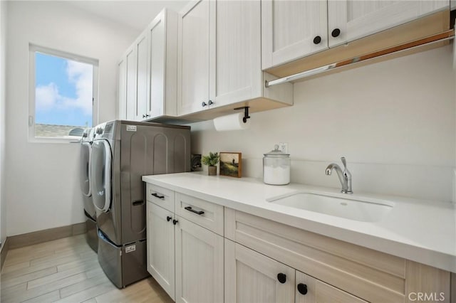 1926 Ruhland Ave Unit B, Redondo Beach, CA 90278 - laundry room with washer and dryer, cabinet space, light wood-type flooring, and baseboards
