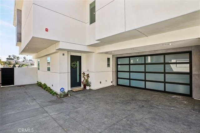 1926 Ruhland Ave Unit B, Redondo Beach, CA 90278 - view of exterior entry with a garage, stucco siding, and driveway