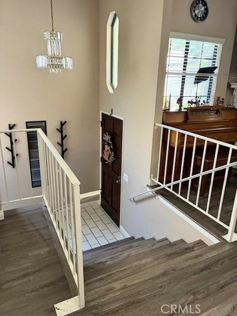 2249 Montrose Ave Unit 7, Montrose, CA 91020 - foyer entrance featuring wood finished floors, stairway, baseboards, and a chandelier