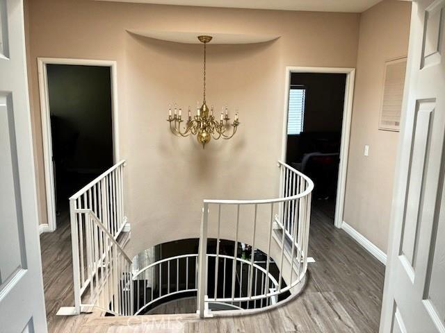 2249 Montrose Ave Unit 7, Montrose, CA 91020 - stairway featuring a chandelier, wood finished floors, and baseboards
