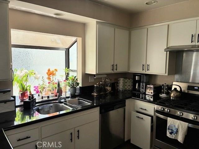 2249 Montrose Ave Unit 7, Montrose, CA 91020 - kitchen featuring appliances with stainless steel finishes, a sink, white cabinetry, and dark countertops