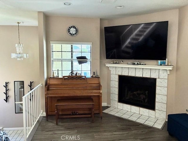 2249 Montrose Ave Unit 7, Montrose, CA 91020 - living area with wood finished floors, a tile fireplace, a chandelier, baseboards, and recessed lighting