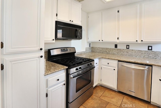 23 Gauguin Cir, Aliso Viejo, CA 92656 - kitchen with stainless steel appliances, white cabinetry, light tile patterned floors, and light stone countertops