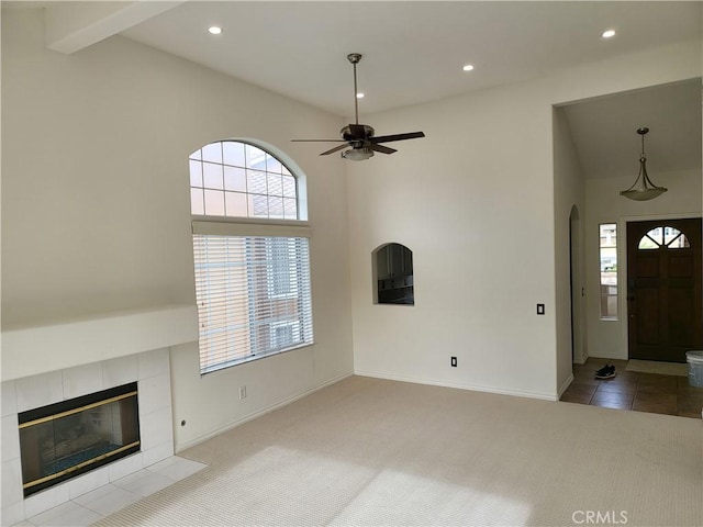 23 Gauguin Cir, Aliso Viejo, CA 92656 - unfurnished living room featuring ceiling fan, arched walkways, recessed lighting, carpet floors, and a tile fireplace