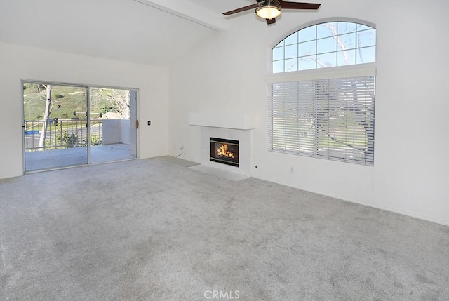 23 Gauguin Cir, Aliso Viejo, CA 92656 - unfurnished living room featuring beam ceiling, plenty of natural light, a fireplace with flush hearth, a ceiling fan, and carpet floors