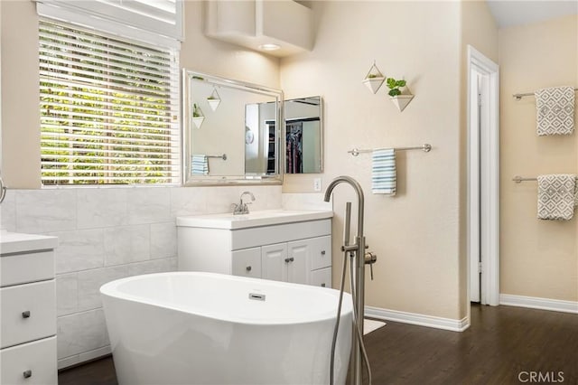 31291 Via Fajita, San Juan Capistrano, CA 92675 - full bath with vanity, a soaking tub, wood finished floors, baseboards, and tile walls