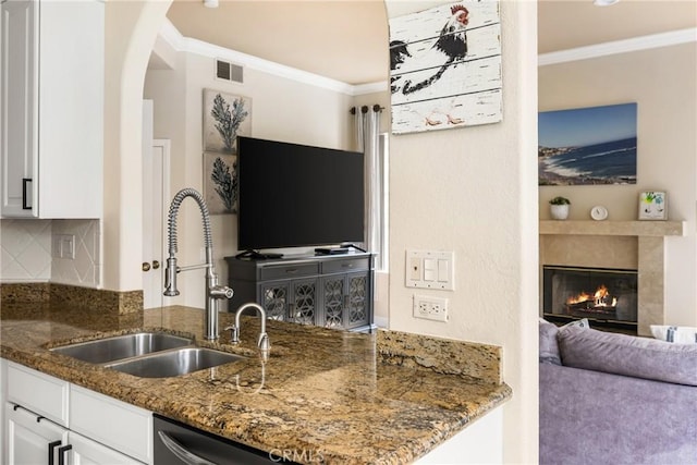 31291 Via Fajita, San Juan Capistrano, CA 92675 - kitchen featuring a sink, crown molding, white cabinetry, dark stone counters, and tasteful backsplash