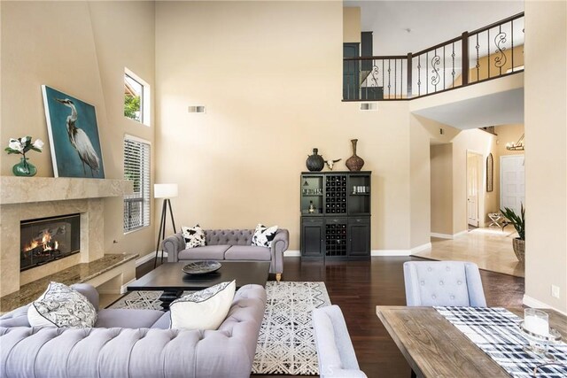 31291 Via Fajita, San Juan Capistrano, CA 92675 - living room featuring a high ceiling, wood finished floors, baseboards, and a high end fireplace
