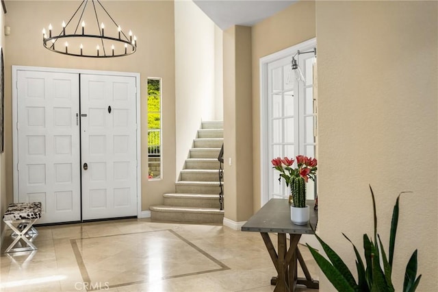 31291 Via Fajita, San Juan Capistrano, CA 92675 - entrance foyer with inlaid floor details, a chandelier, baseboards, and stairs