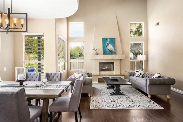 31291 Via Fajita, San Juan Capistrano, CA 92675 - living area with wood finished floors, a chandelier, a towering ceiling, a fireplace, and baseboards