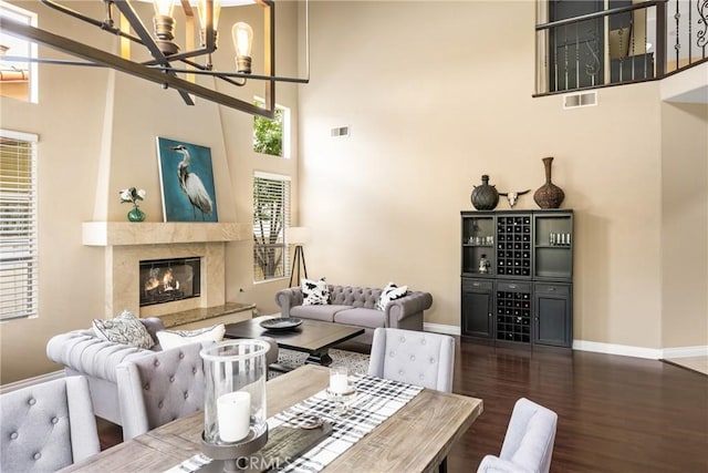 31291 Via Fajita, San Juan Capistrano, CA 92675 - living area with a chandelier, a towering ceiling, wood finished floors, baseboards, and a high end fireplace