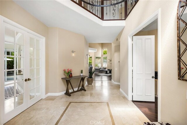 31291 Via Fajita, San Juan Capistrano, CA 92675 - tiled foyer with baseboards, french doors, inlaid floor details, and a towering ceiling