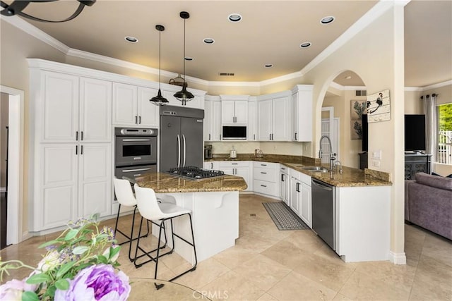 31291 Via Fajita, San Juan Capistrano, CA 92675 - kitchen featuring appliances with stainless steel finishes, a sink, ornamental molding, a kitchen breakfast bar, and arched walkways