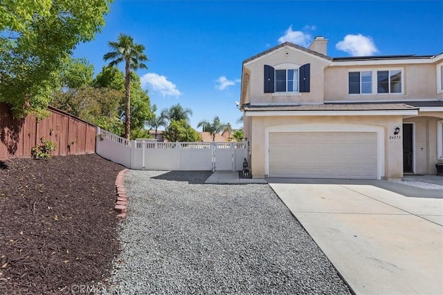 26273 Palm Tree Ln, Murrieta, CA 92563 - view of home's exterior featuring stucco siding, a chimney, concrete driveway, an attached garage, and a gate
