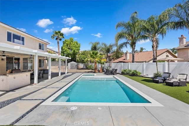 26273 Palm Tree Ln, Murrieta, CA 92563 - view of swimming pool with a fenced backyard, ceiling fan, a patio, and an outdoor kitchen