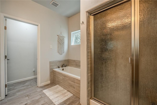 21604 Adam Dr, Tehachapi, CA 93561 - full bath featuring a bath, a stall shower, wood finished floors, and baseboards