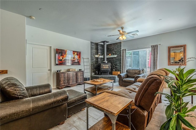 21604 Adam Dr, Tehachapi, CA 93561 - living area with a wood stove, ceiling fan, and light wood finished floors
