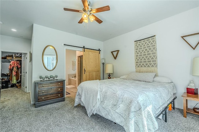 21604 Adam Dr, Tehachapi, CA 93561 - bedroom featuring a walk in closet, carpet floors, a closet, and a barn door