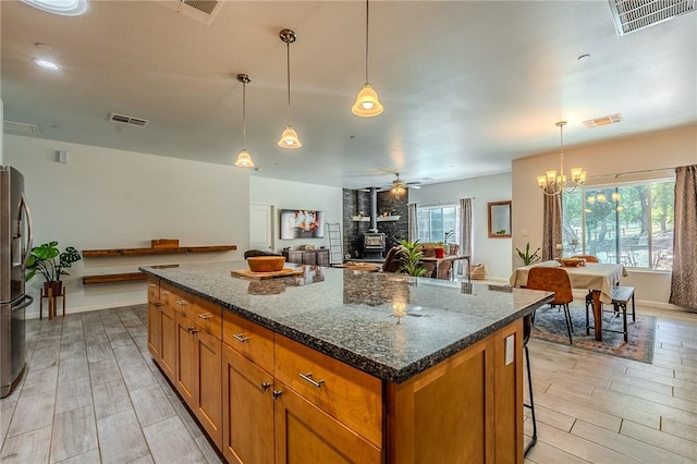 21604 Adam Dr, Tehachapi, CA 93561 - kitchen with brown cabinets, plenty of natural light, and open floor plan