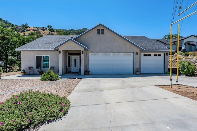 21604 Adam Dr, Tehachapi, CA 93561 - ranch-style house featuring an attached garage, stucco siding, concrete driveway, and a shingled roof