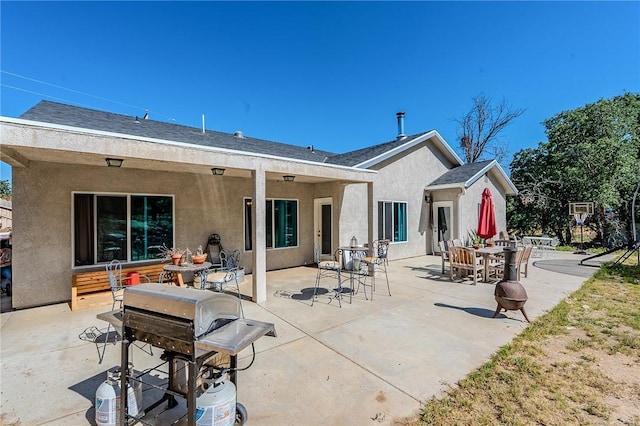 21604 Adam Dr, Tehachapi, CA 93561 - back of property with stucco siding, a patio, and outdoor dining space