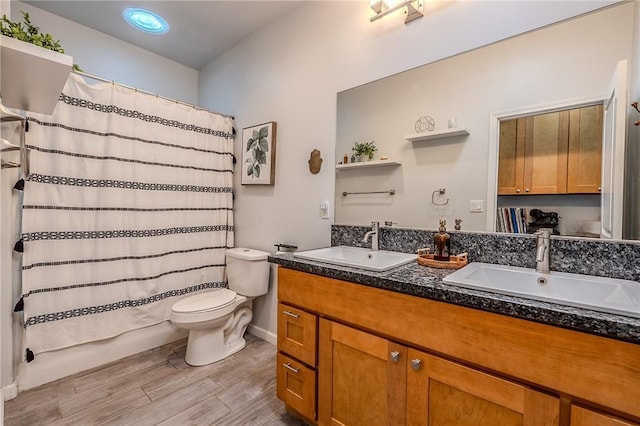 21604 Adam Dr, Tehachapi, CA 93561 - full bath with double vanity, toilet, wood finished floors, and baseboards