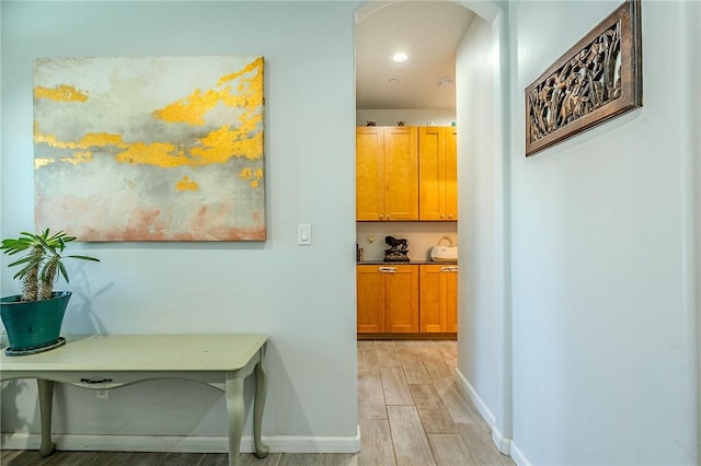 21604 Adam Dr, Tehachapi, CA 93561 - hallway featuring light wood-type flooring, arched walkways, and baseboards