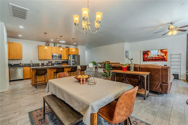 21604 Adam Dr, Tehachapi, CA 93561 - dining area with light wood-style flooring, a chandelier, ceiling fan, and recessed lighting