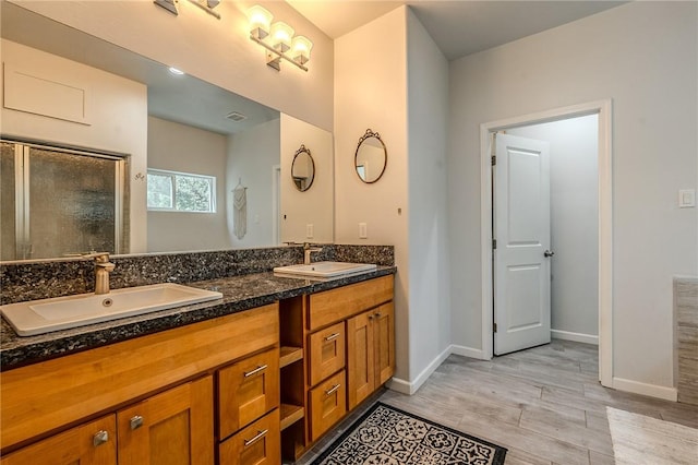 21604 Adam Dr, Tehachapi, CA 93561 - full bath featuring double vanity, wood finished floors, a stall shower, and baseboards