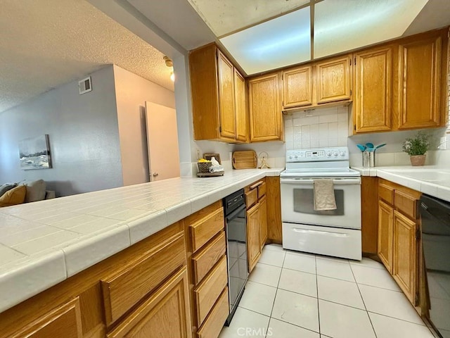 4142 E Mendez St Unit 132, Long Beach, CA 90815 - kitchen with white range with electric cooktop, black dishwasher, brown cabinets, light tile patterned floors, and decorative backsplash