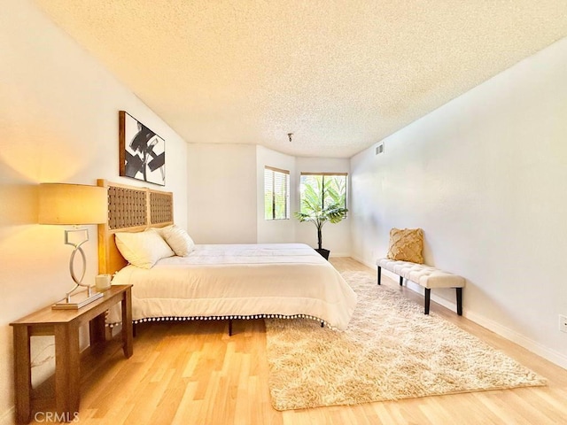 4142 E Mendez St Unit 132, Long Beach, CA 90815 - bedroom with a textured ceiling, wood finished floors, and baseboards