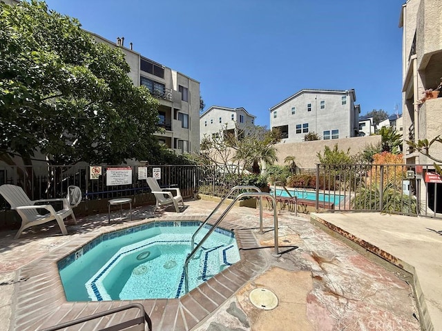 4142 E Mendez St Unit 132, Long Beach, CA 90815 - view of swimming pool with a hot tub, a patio area, and a residential view