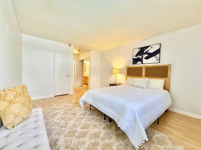 4142 E Mendez St Unit 132, Long Beach, CA 90815 - bedroom with light wood-style flooring, baseboards, and a textured ceiling