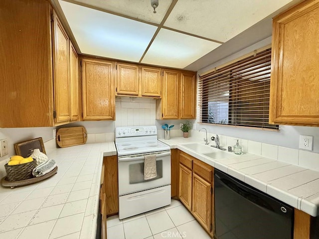 4142 E Mendez St Unit 132, Long Beach, CA 90815 - kitchen with electric range, dishwasher, a sink, brown cabinets, and light tile patterned floors