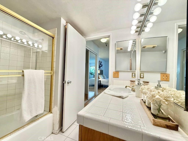 4142 E Mendez St Unit 132, Long Beach, CA 90815 - ensuite bathroom featuring combined bath / shower with glass door, vanity, and tile patterned flooring