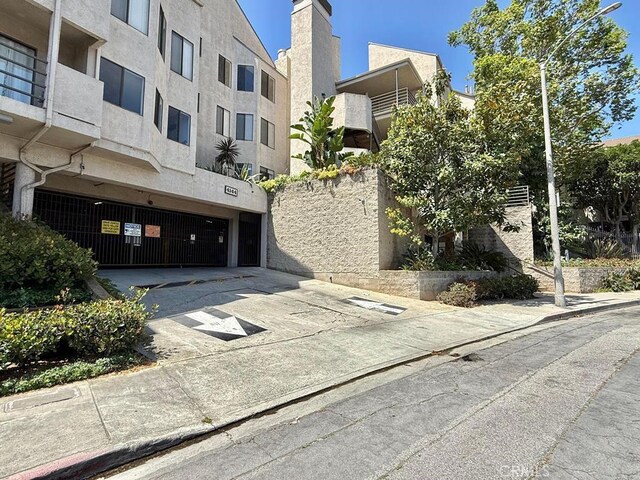 4142 E Mendez St Unit 132, Long Beach, CA 90815 - view of property featuring a garage and driveway