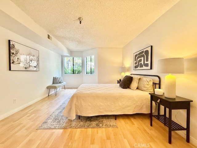4142 E Mendez St Unit 132, Long Beach, CA 90815 - bedroom with a textured ceiling, wood finished floors, and baseboards