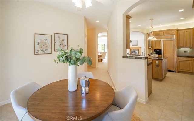 570 Jenny Pl, Arroyo Grande, CA 93420 - dining room featuring arched walkways, light tile patterned floors, recessed lighting, a ceiling fan, and baseboards