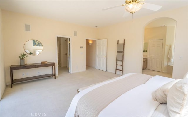 570 Jenny Pl, Arroyo Grande, CA 93420 - bedroom with arched walkways, light colored carpet, a walk in closet, ensuite bath, and baseboards